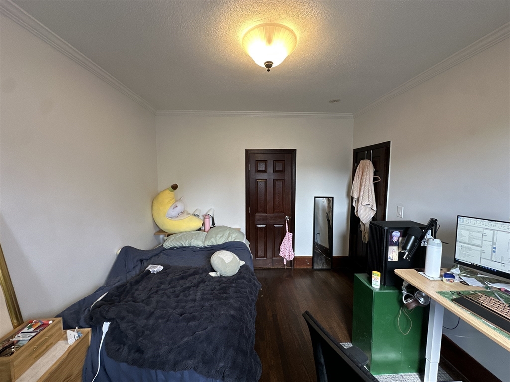 435 Walnut Avenue, Unit 8 Boston, MA 02119 - Photo 5 of 12 a living room with furniture and a flat screen tv