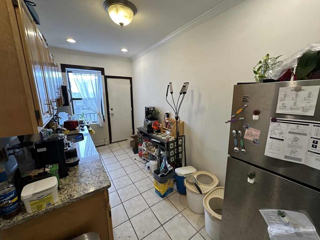 435 Walnut Avenue, Unit 8 Boston, MA 02119 - Photo 6 of 12 a room with furniture and a flat screen tv