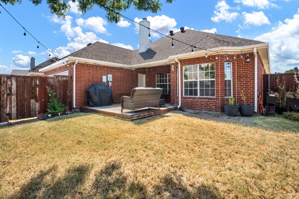 11414 Promenade Road Frisco, TX 75035 - Photo 21 of 24 Brick exterior featuring a wooden deck and a private perimeter fence