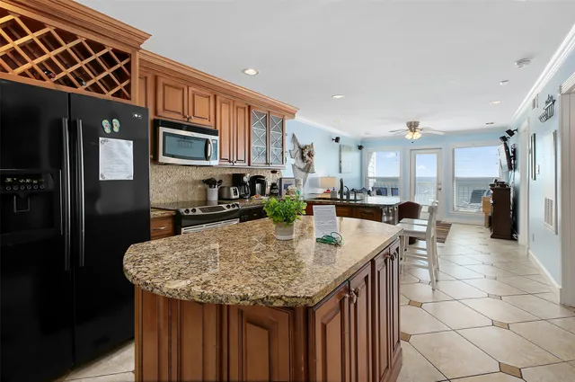 a kitchen with stainless steel appliances granite countertop a sink and cabinets