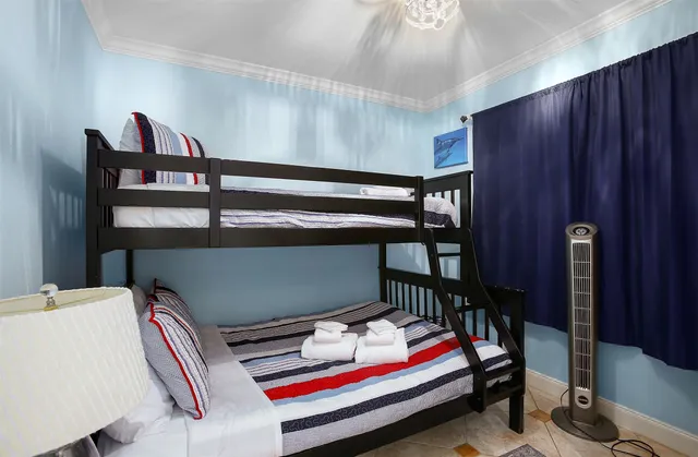 a room with bunk bed and a window