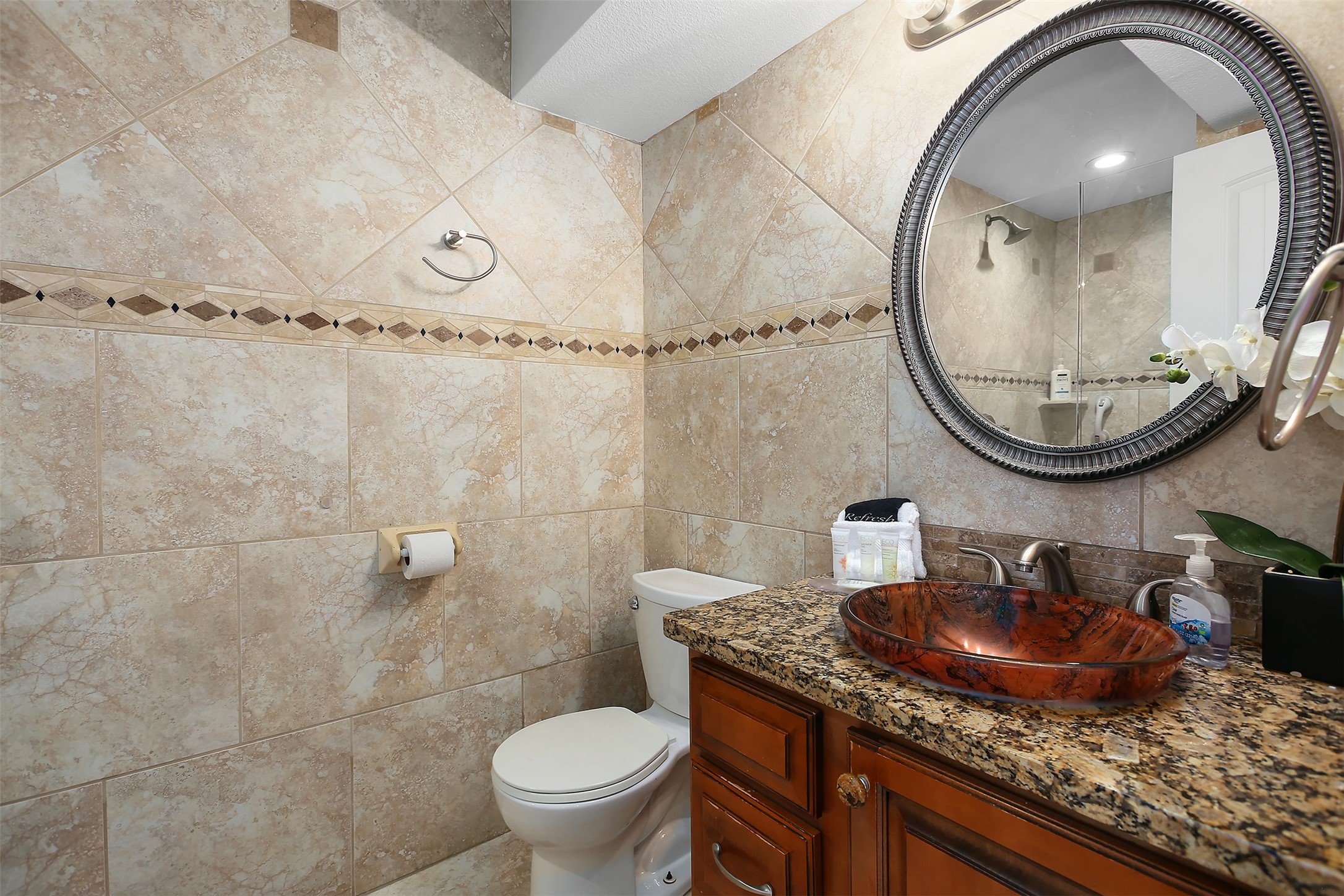 10811 Termini-San Luis Pass Road, Unit 2112 Galveston, TX 77554 - Photo 17 of 22 a bathroom with a sink a mirror and a toilet