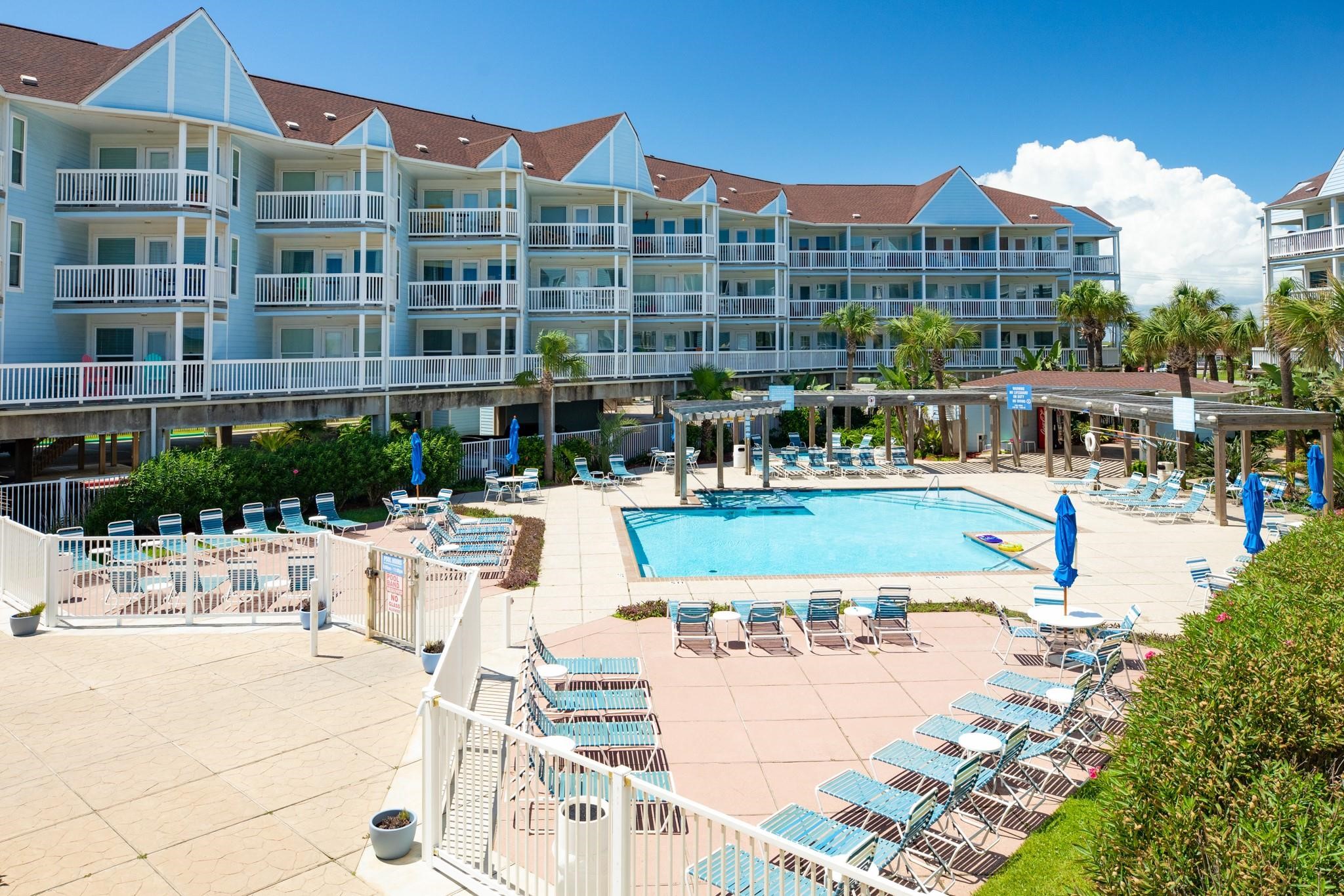 10811 Termini-San Luis Pass Road, Unit 2112 Galveston, TX 77554 - Photo 20 of 22 a view of multiple houses with a swimming pool
