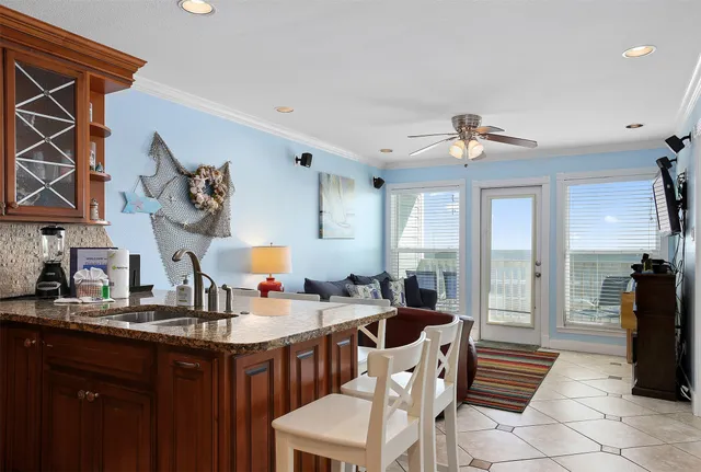 a kitchen with stainless steel appliances granite countertop a sink a stove and a refrigerator