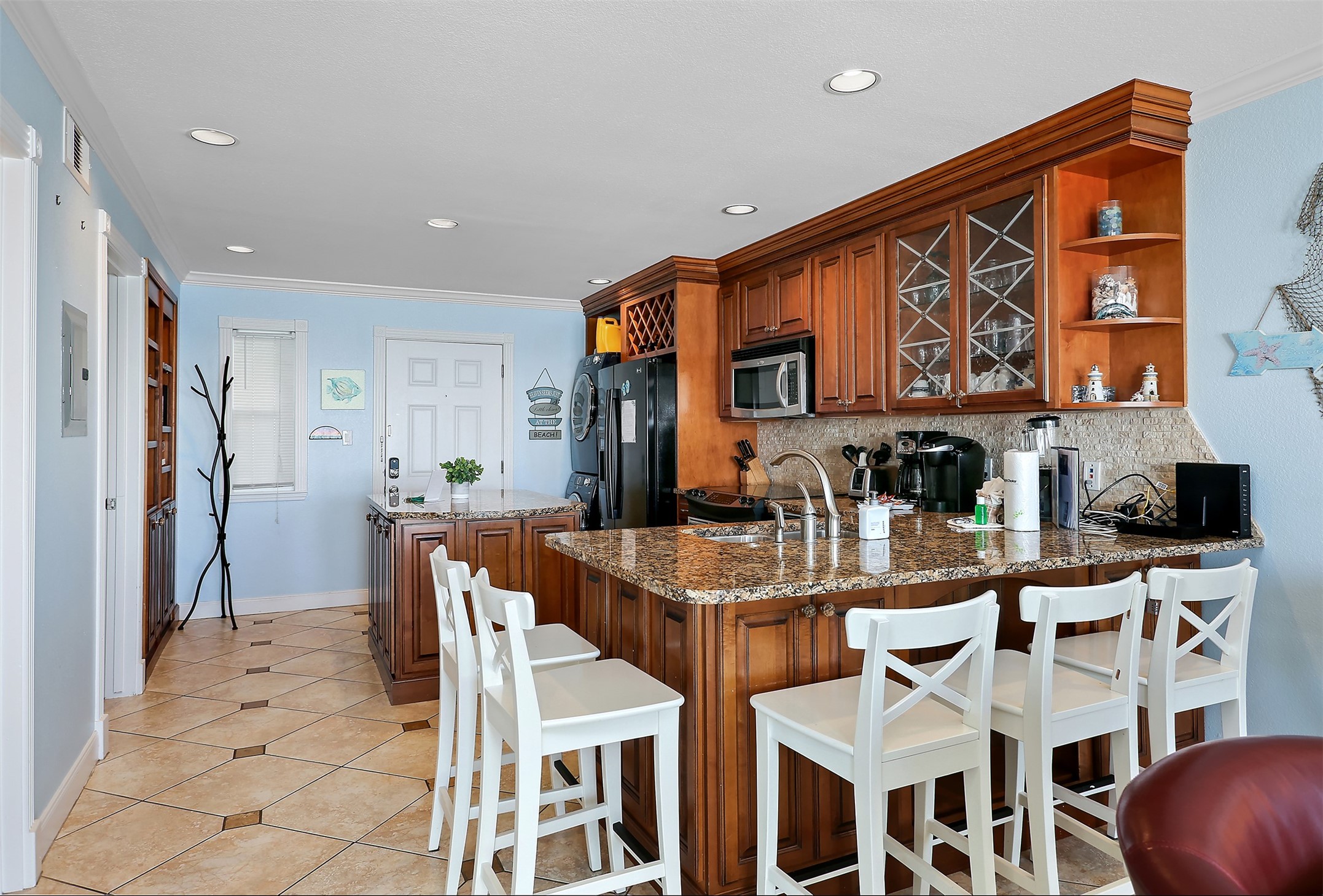 10811 Termini-San Luis Pass Road, Unit 2112 Galveston, TX 77554 - Photo 3 of 22 a dinning table and chairs in a kitchen