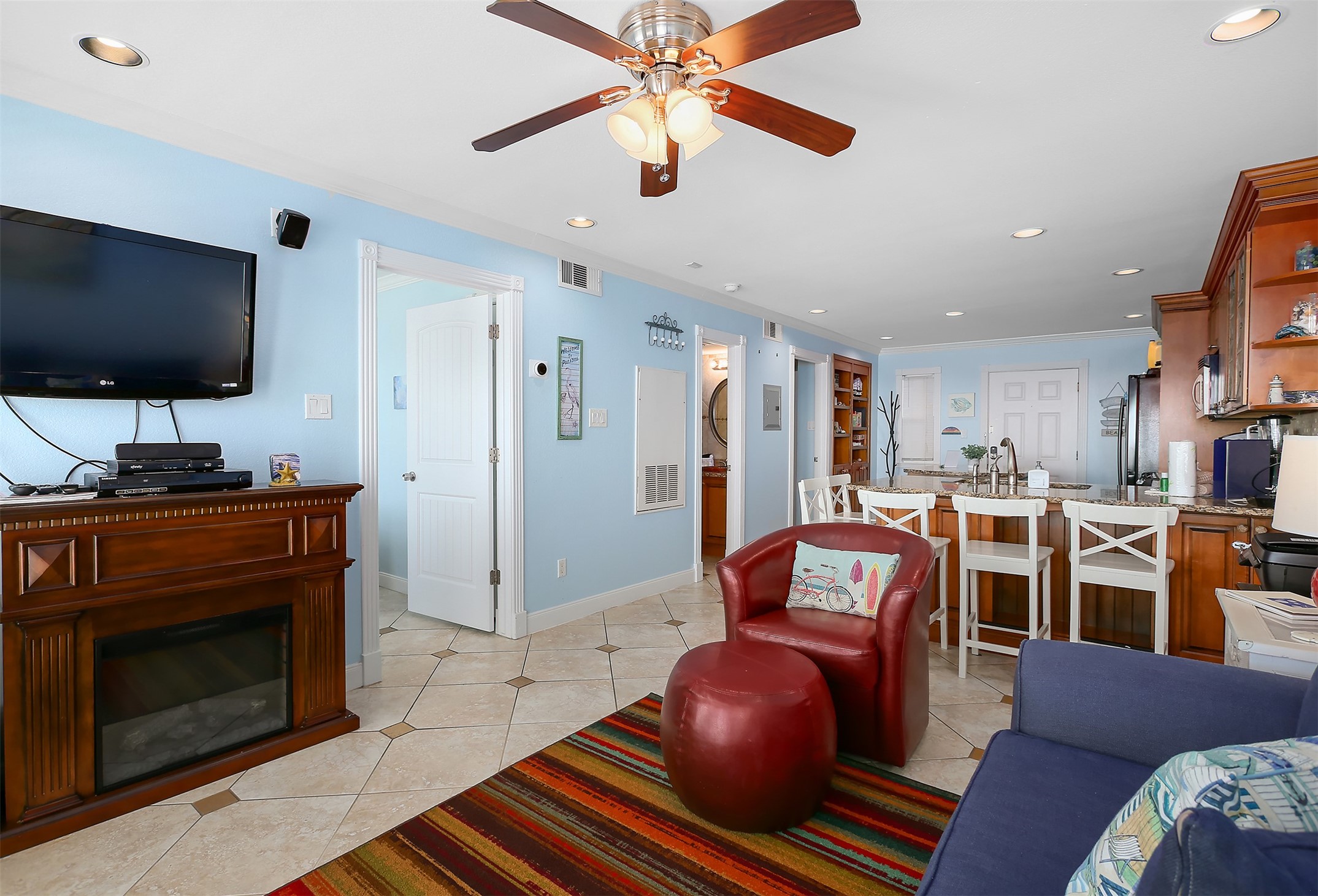 10811 Termini-San Luis Pass Road, Unit 2112 Galveston, TX 77554 - Photo 8 of 22 a living room with furniture a flat screen tv and kitchen view