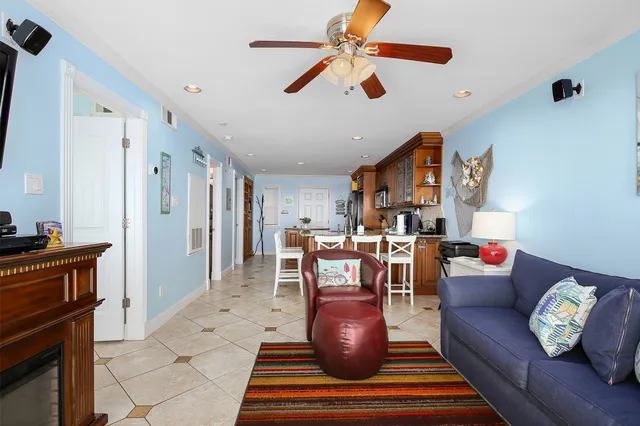 a living room with furniture and a dining table