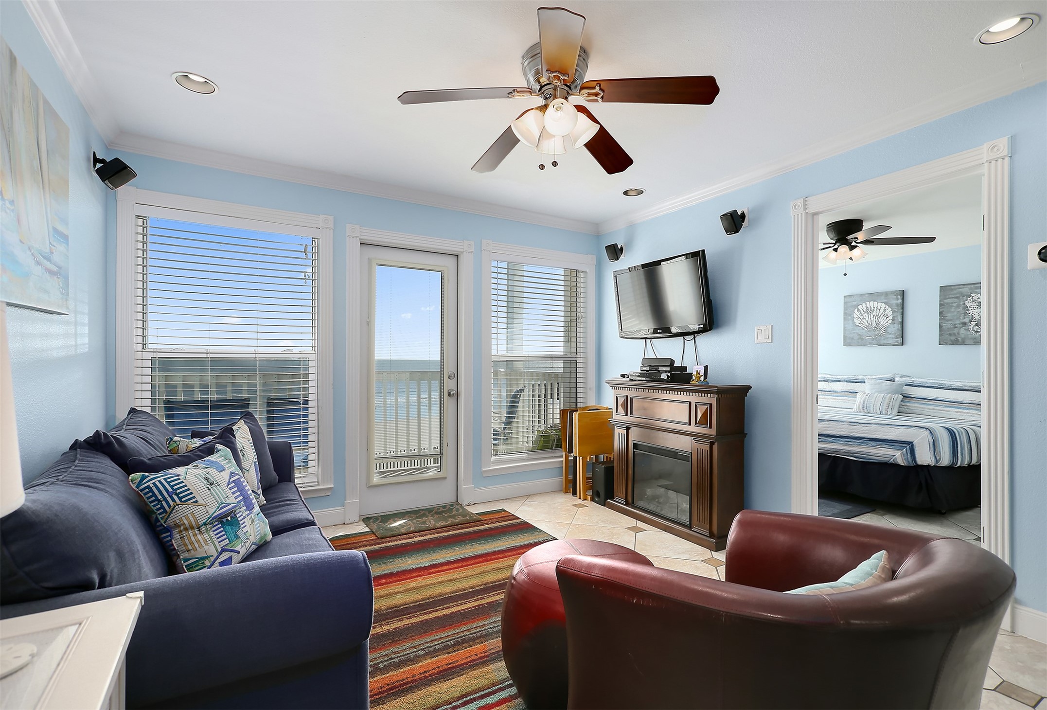 10811 Termini-San Luis Pass Road, Unit 2112 Galveston, TX 77554 - Photo 10 of 22 a living room with furniture and a flat screen tv