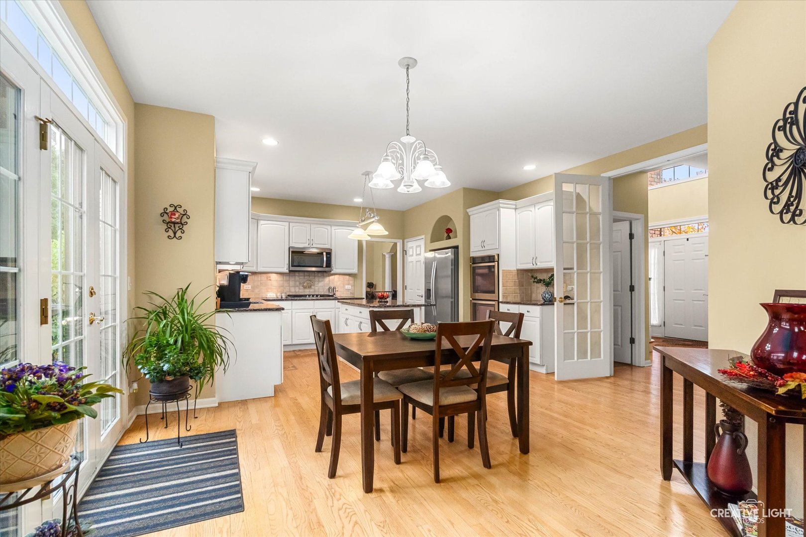 2543 Dewes Lane Naperville, IL 60564 - Photo 13 of 47 a view of a dining room with furniture and wooden floor