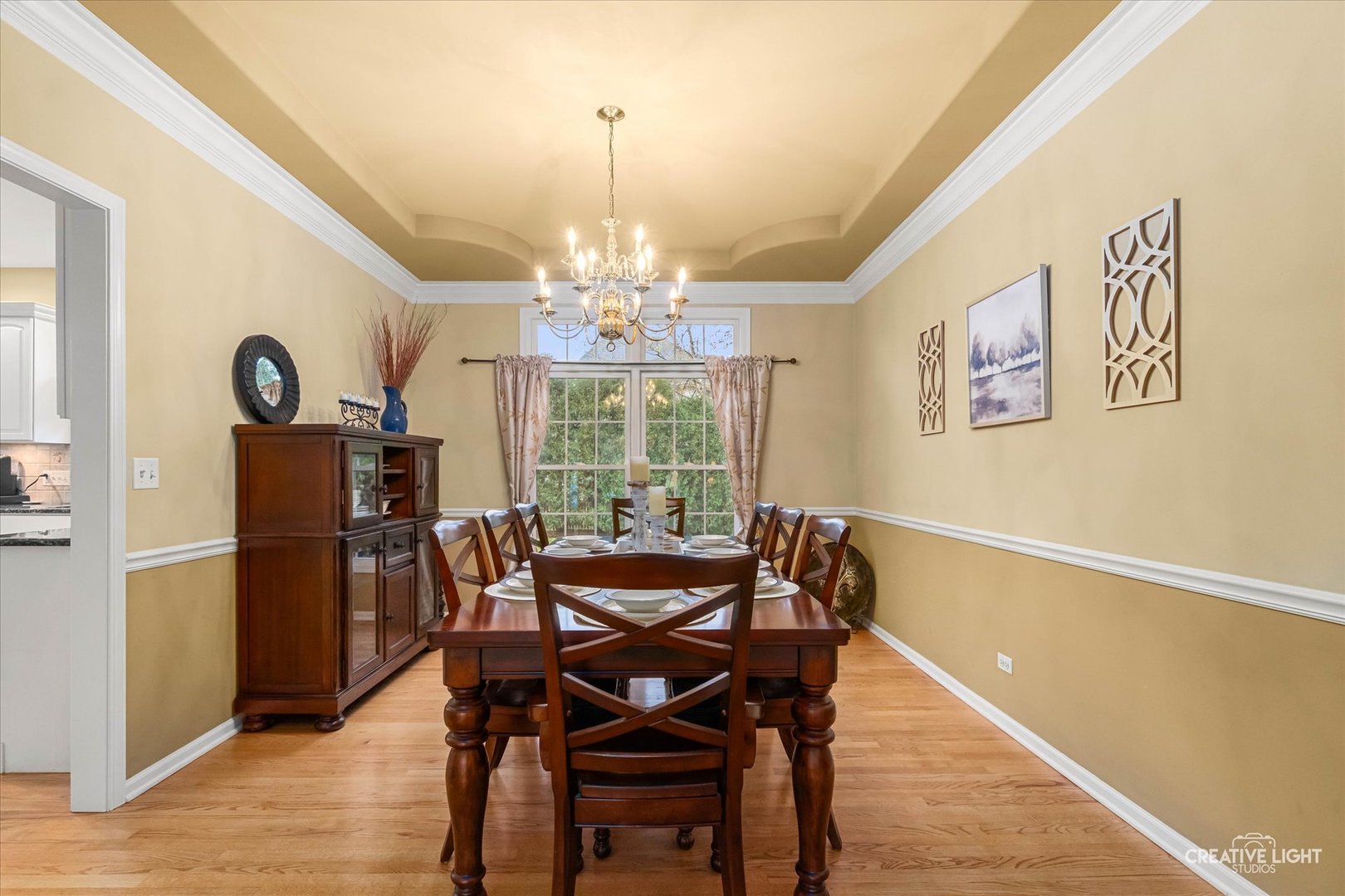 2543 Dewes Lane Naperville, IL 60564 - Photo 6 of 47 a view of a dining room with furniture a chandelier and wooden floor