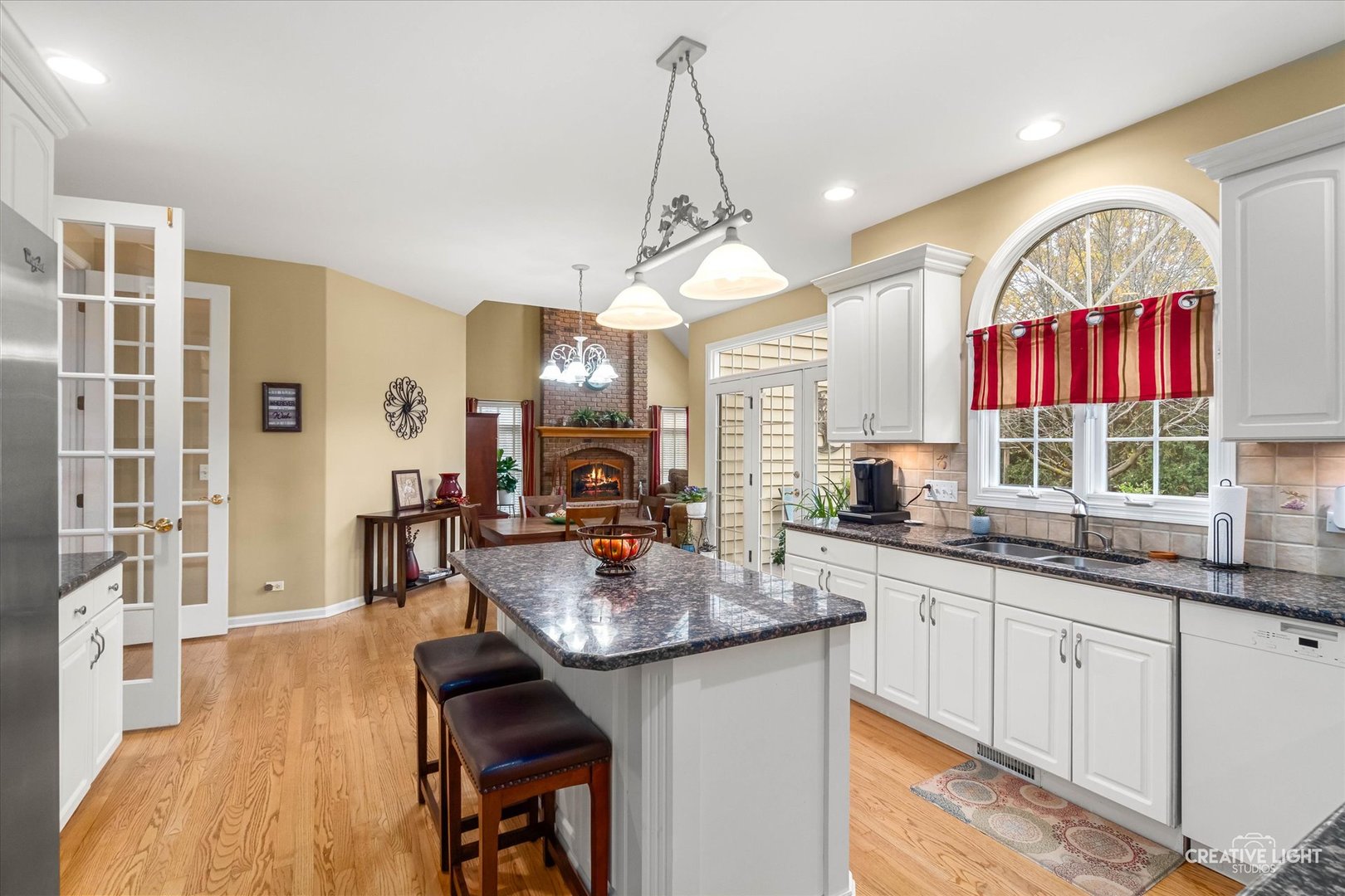 2543 Dewes Lane Naperville, IL 60564 - Photo 7 of 47 a kitchen with kitchen island granite countertop a sink cabinets and wooden floor