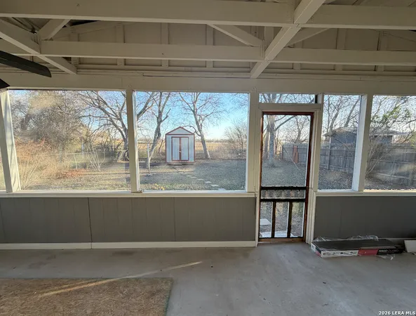 a view of a livingroom with an empty space and a window