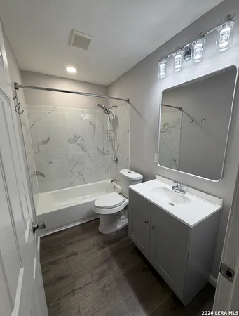 a bathroom with a double vanity sink toilet and shower