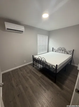 a bedroom with a bed and window