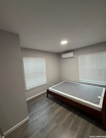 a bathroom with a bathtub and a window
