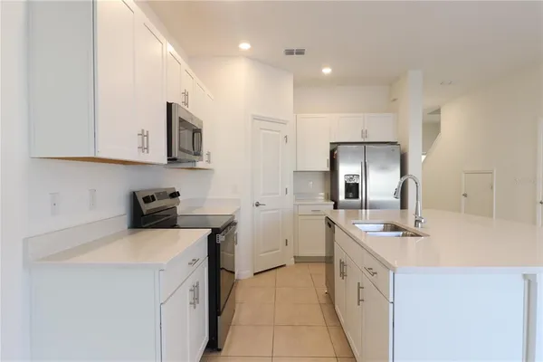 a kitchen with a sink stove and cabinets