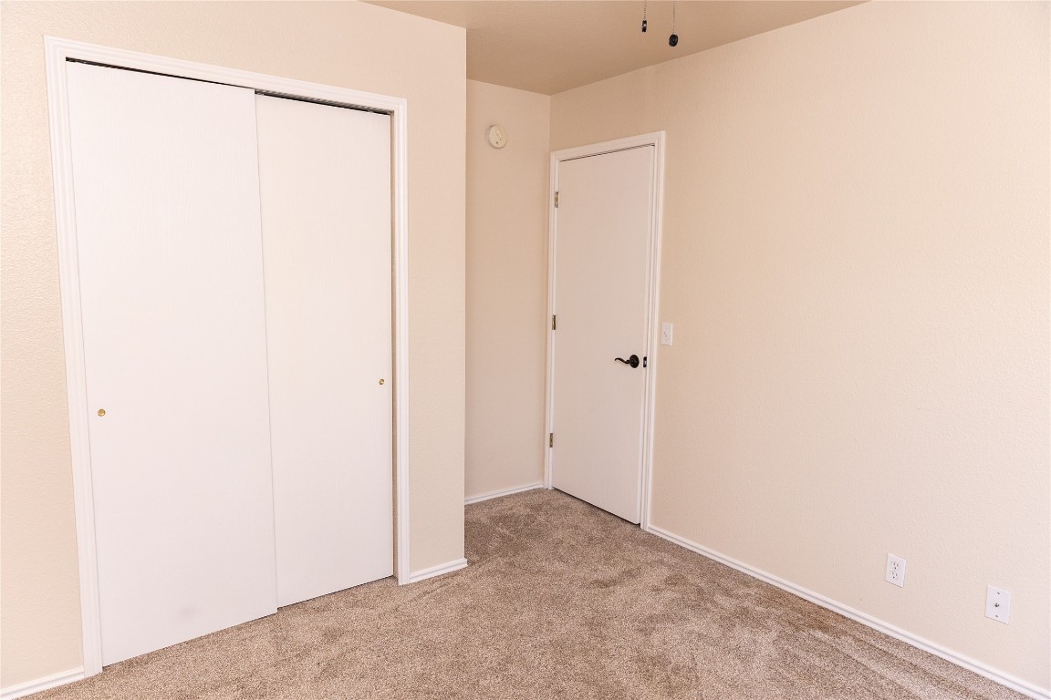 184 Unity Kyle, TX 78640 - Photo 17 of 33 Unfurnished bedroom with light carpet and a closet