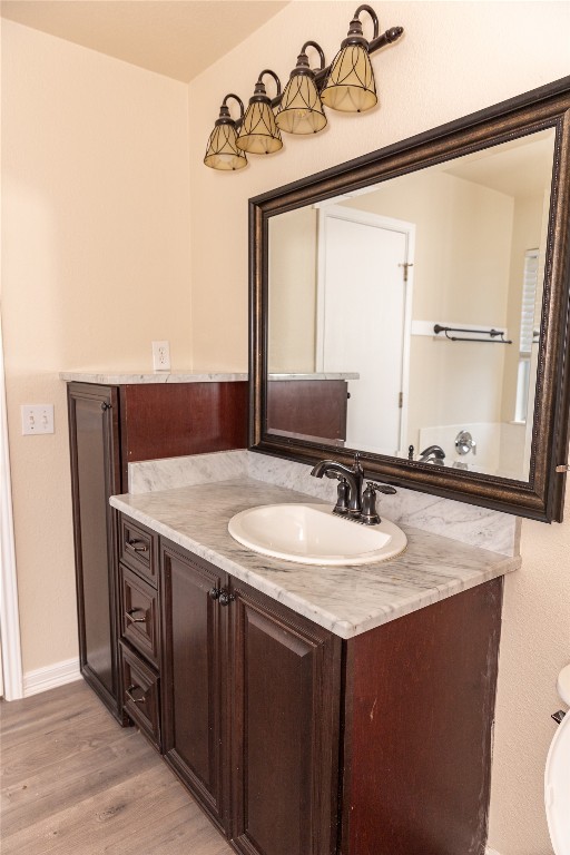 184 Unity Kyle, TX 78640 - Photo 19 of 33 Bathroom featuring vanity and light wood-style flooring
