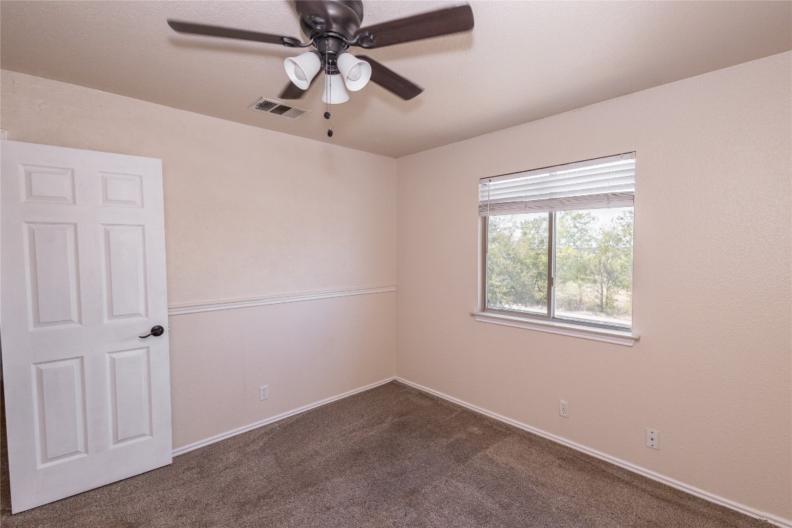 184 Unity Kyle, TX 78640 - Photo 24 of 33 Spare room with dark colored carpet and a ceiling fan