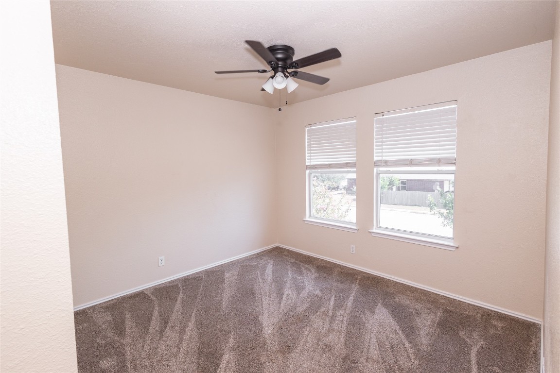 184 Unity Kyle, TX 78640 - Photo 26 of 33 Carpeted spare room featuring a ceiling fan and baseboards