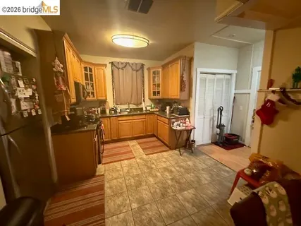 a large bedroom with a bed and wooden floor