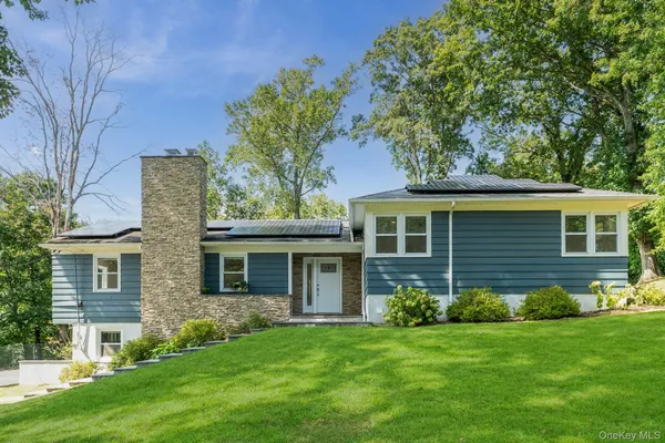 a front view of a house with a garden