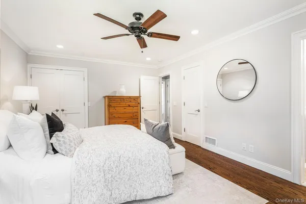 a bedroom with a large bed and a chandelier