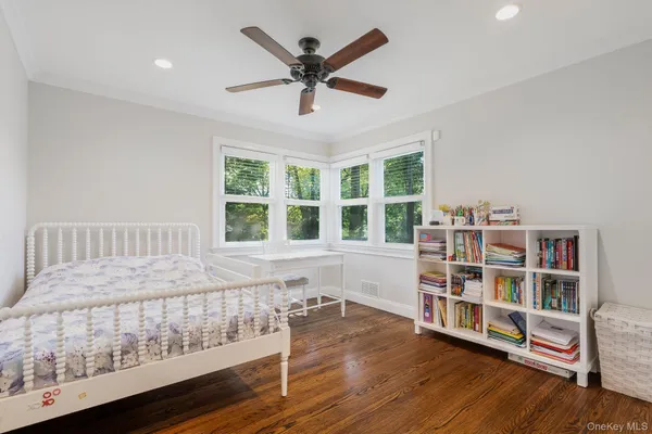 a bedroom with furniture and a book shelf
