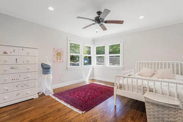 a living room with a bed and a window