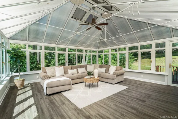 a living room with furniture windows and wooden floor