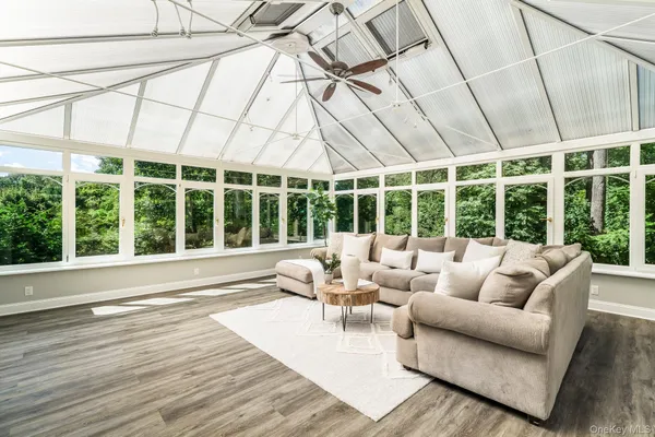 a living room with furniture and large windows