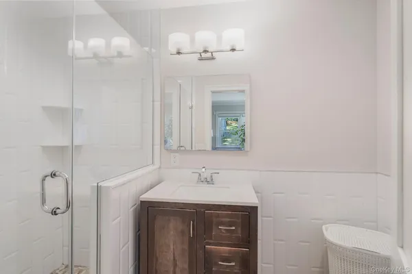 a bathroom with a sink a toilet and mirror