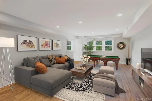 a living room with furniture a large window and a flat screen tv