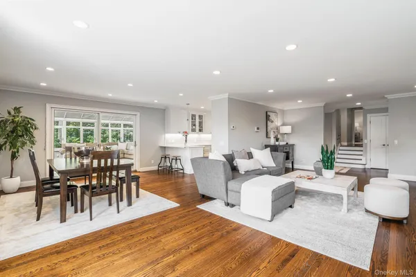 a living room with furniture a wooden floor and a dining table with wooden floor