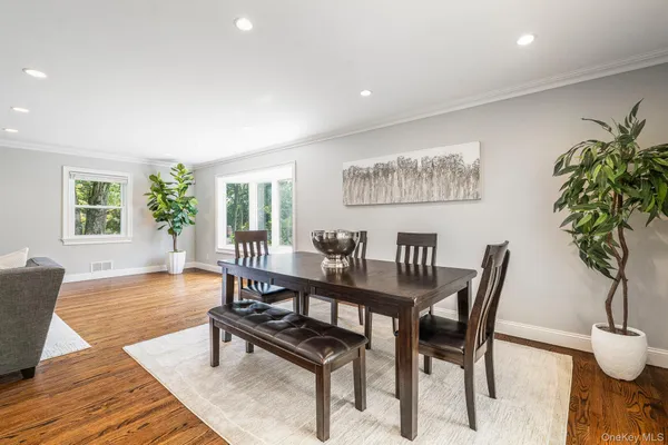 a view of a dining room with furniture window and wooden floor