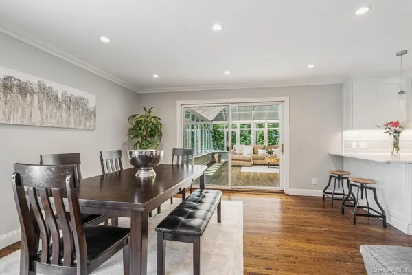 a view of a dining room with furniture window and wooden floor