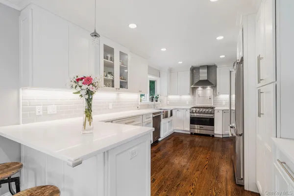 a kitchen with granite countertop a sink and a stove top oven