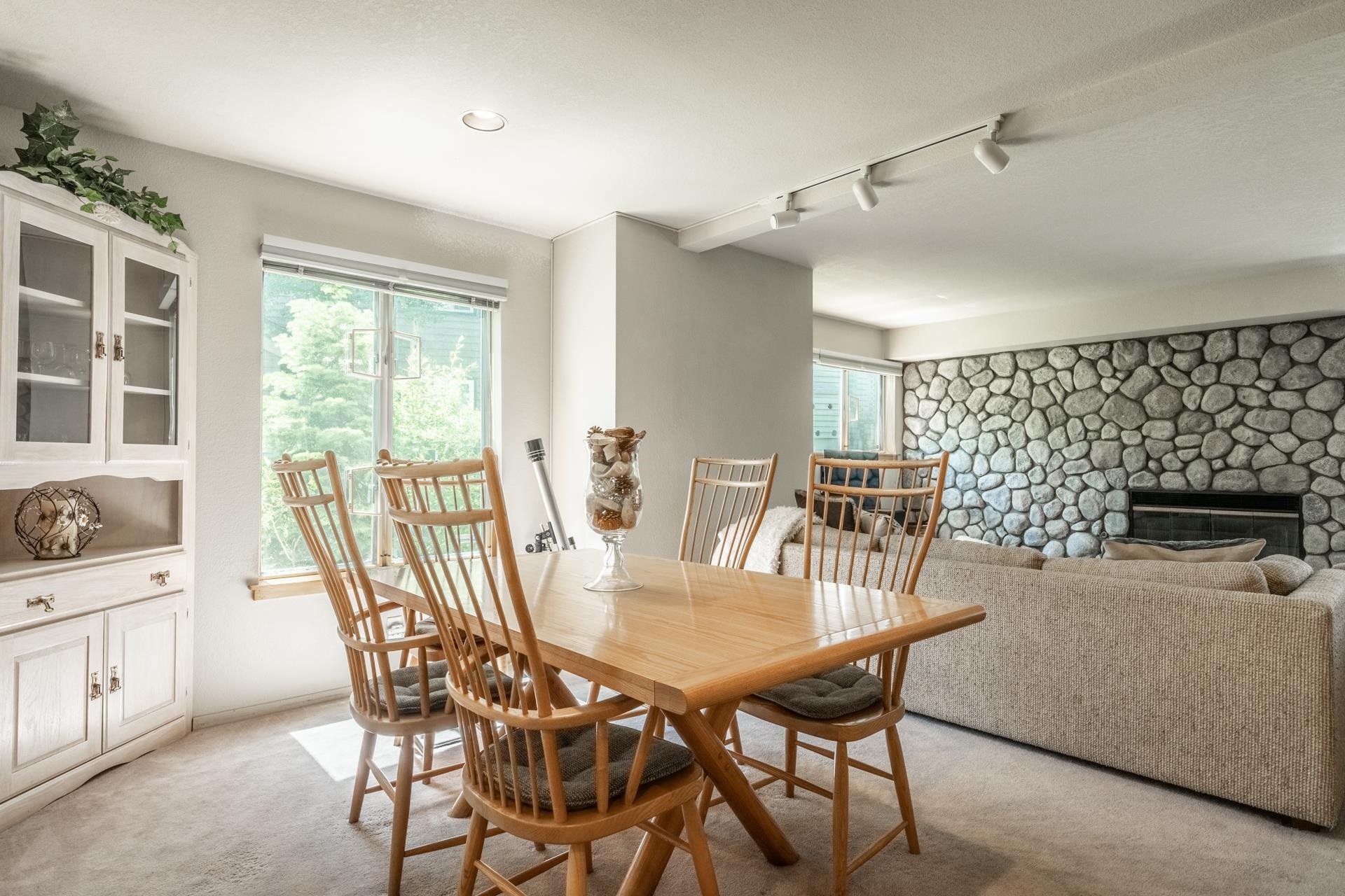 609 Golden Creek Road, Unit 609 Mammoth Lakes, CA 93546 - Photo 24 of 42 Carpeted dining area featuring a built-in display cabinet with glass doors, recessed lighting, and a window with exterior tree scenery