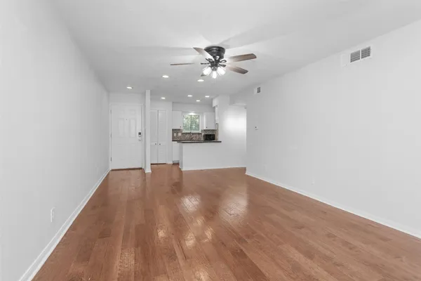a kitchen with white cabinets and a fireplace