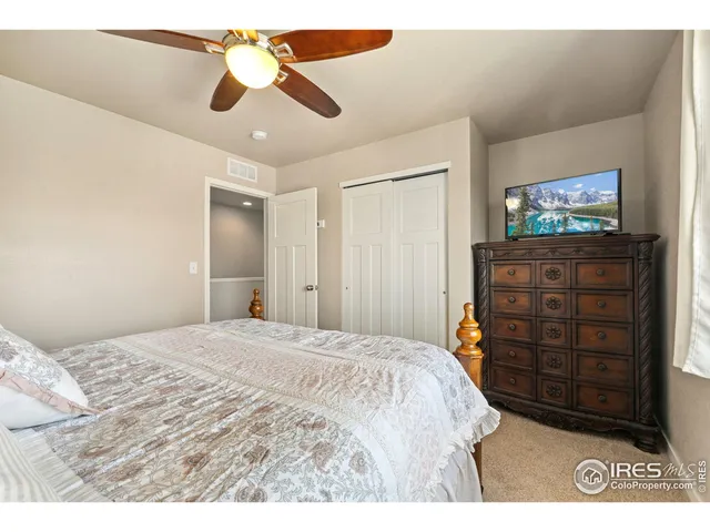 a bedroom with a bed and a television