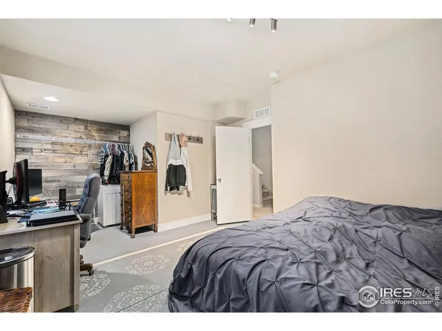 a bedroom with a bed a desk and chair