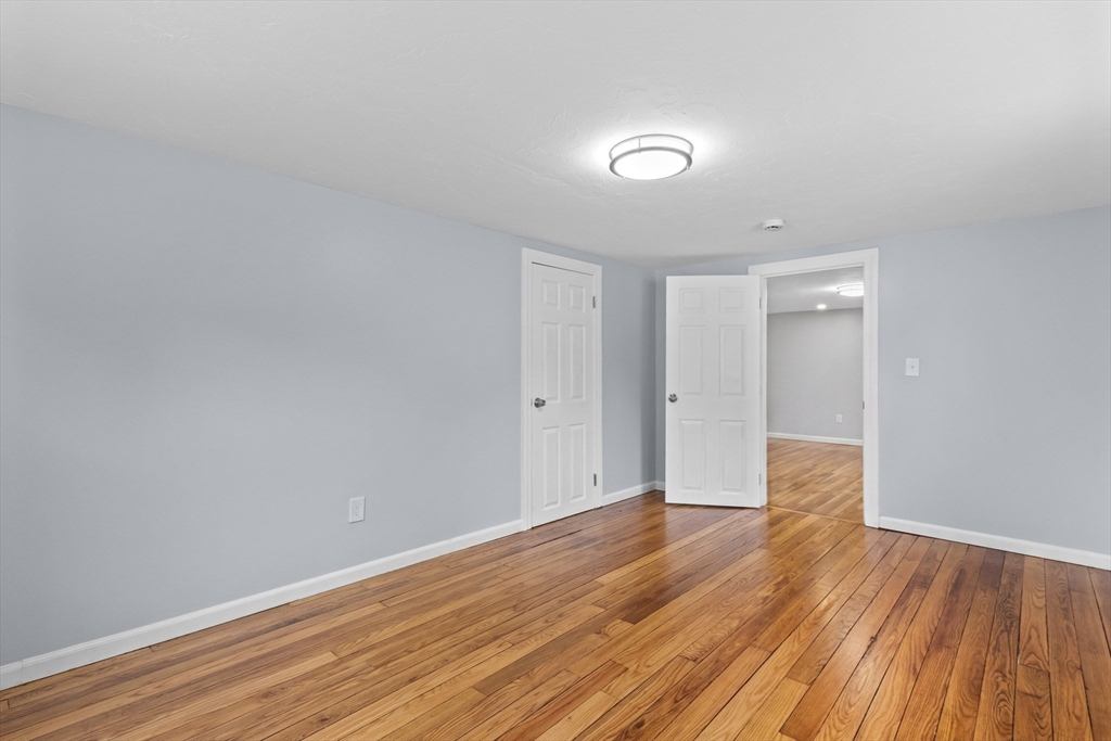 5 Phoenix Street Worcester, MA 01604 - Photo 20 of 32 a view of an empty room with wooden floor