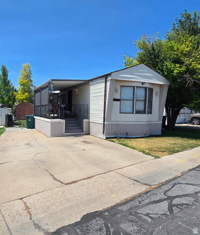 1500 Angel Street North, Unit 53 Layton, UT 84041 - Photo 1 of 20 Single-story residence featuring siding exterior, a covered porch with metal railing, and a bay window