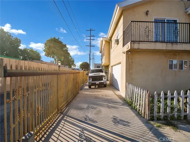 a view of a house with wooden fence