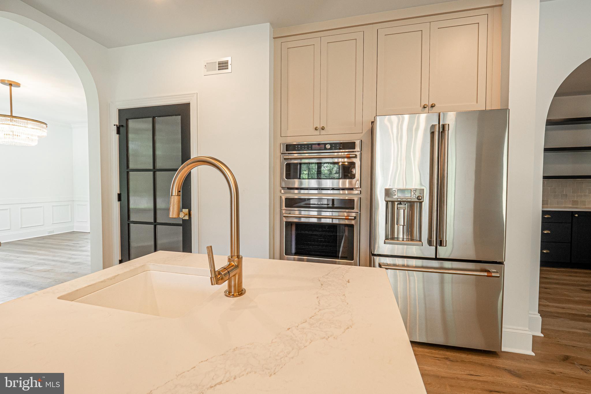 3 Timber Mill Lane, Unit SILENZIO Landenberg, PA 19350 - Photo 14 of 40 a kitchen with kitchen island a counter top space and stainless steel appliances wooden floor