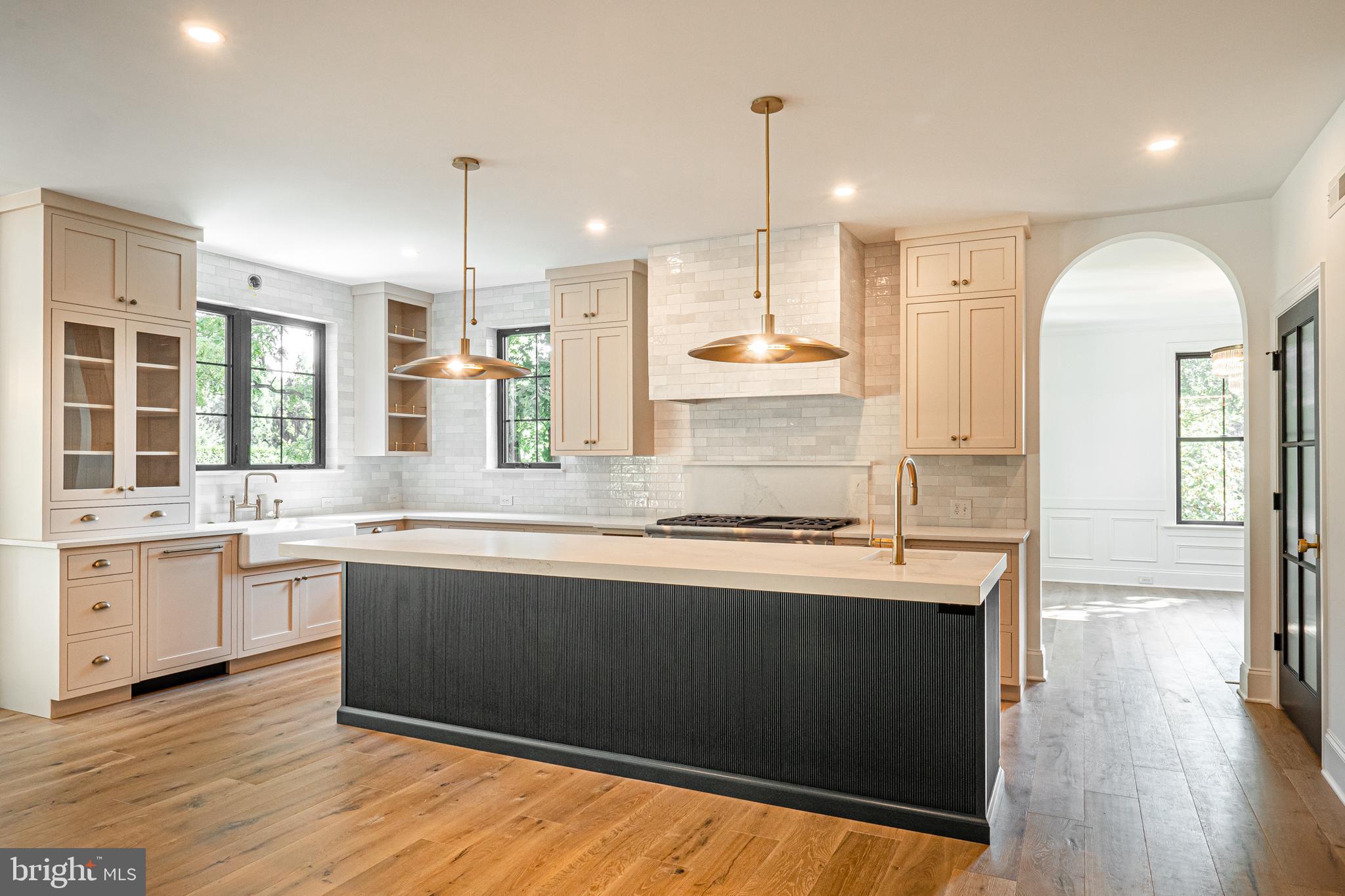 3 Timber Mill Lane, Unit SILENZIO Landenberg, PA 19350 - Photo 5 of 40 a kitchen with stainless steel appliances granite countertop a sink a stove and a wooden floors