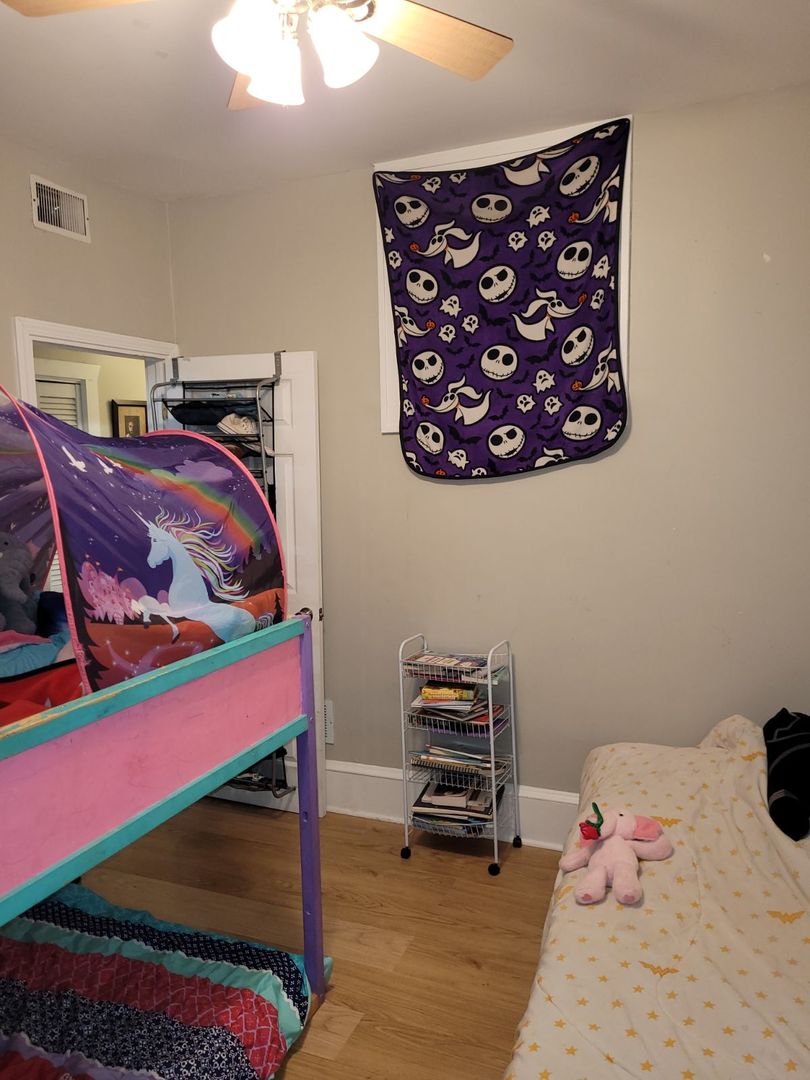 423 East Chicago Street, Unit B Elgin, IL 60120 - Photo 11 of 13 a bedroom with a bed and a dresser in it