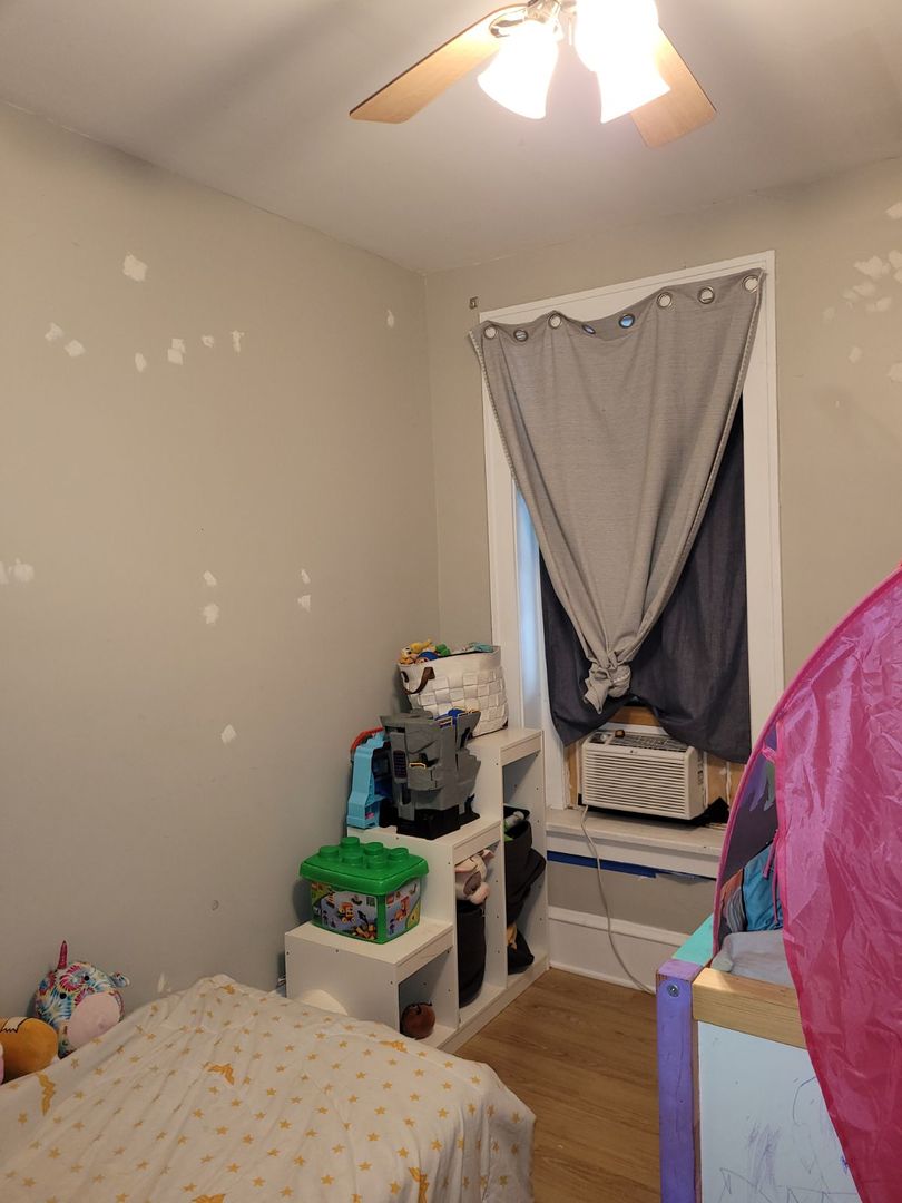 423 East Chicago Street, Unit B Elgin, IL 60120 - Photo 12 of 13 a bedroom with bed and a dresser