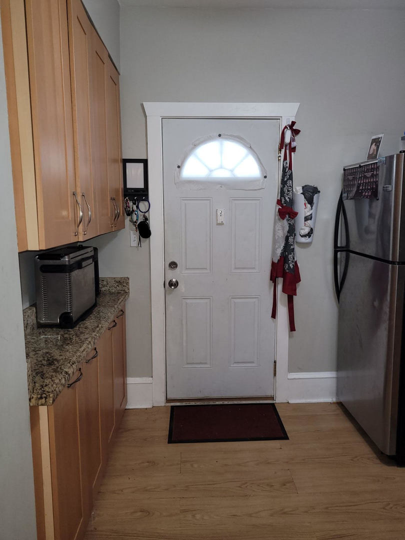 423 East Chicago Street, Unit B Elgin, IL 60120 - Photo 13 of 13 a kitchen with a refrigerator and a stove