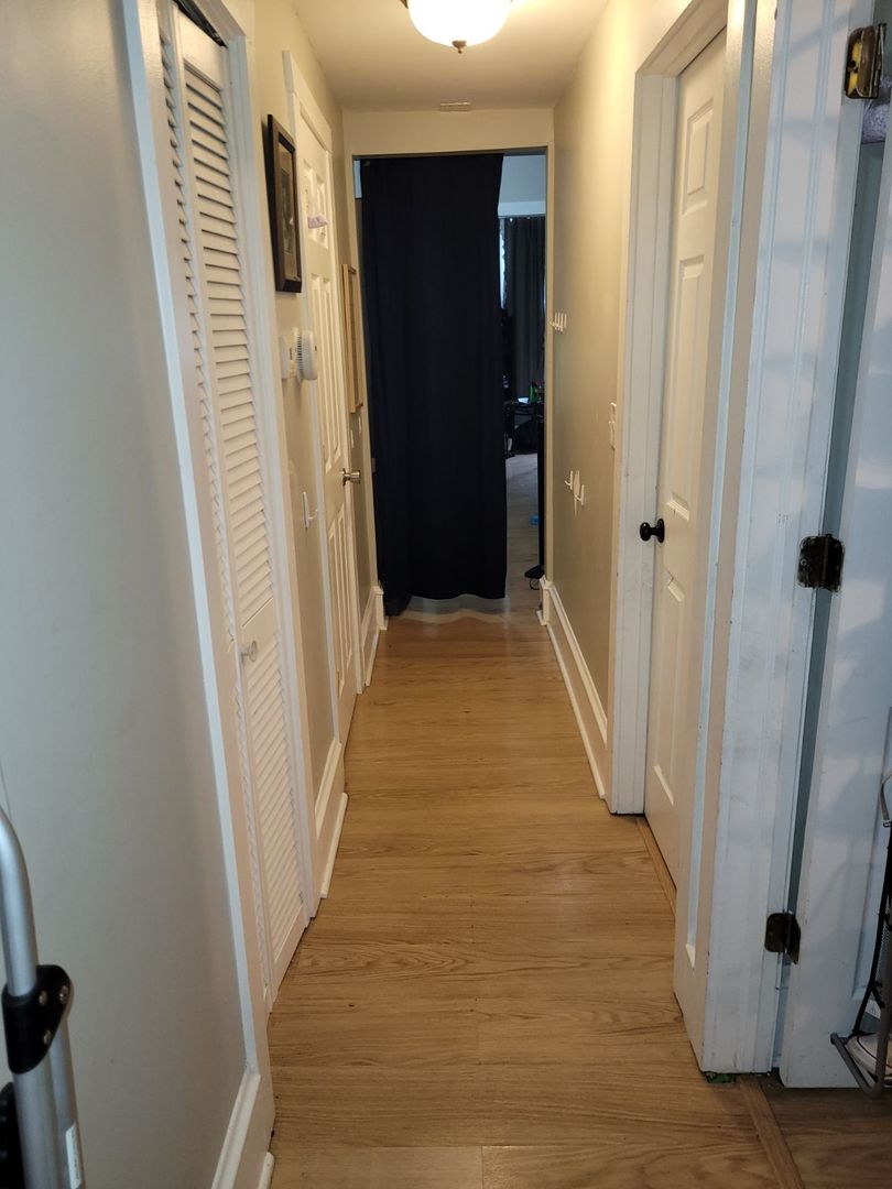 423 East Chicago Street, Unit B Elgin, IL 60120 - Photo 6 of 13 a view of a hallway with wooden floor and staircase